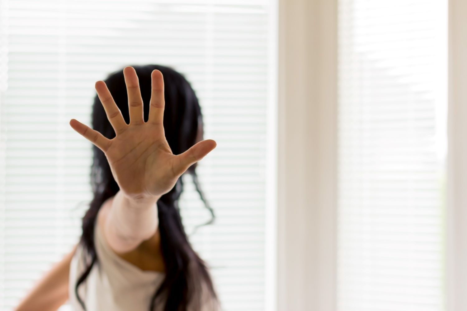 Zu sehen ist: Frau zeigt mit ihrer Hand "Stopp"